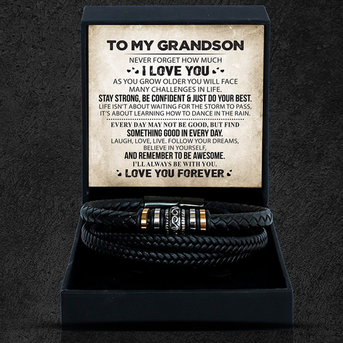 A leather-style bracelet with a black presentation box, containing a heartfelt message card, displayed on a dark background.